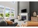 Living room featuring a fireplace, tall ceilings, large windows and comfortable seating at 635 Opera Ln, Alpharetta, GA 30009
