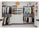 Spacious walk-in closet with custom built-in shelving, drawers, and hanging rods for optimal organization at 635 Opera Ln, Alpharetta, GA 30009