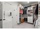 Large walk-in closet with custom storage solutions, including shelving for shoes and accessories, adjacent to the bathroom at 635 Opera Ln, Alpharetta, GA 30009