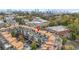 An aerial view of the condo community showcases its proximity to the city skyline and mature trees at 1199 Huff Nw Rd # 112, Atlanta, GA 30318