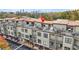 An aerial view of townhome community showcases roof top patios and the city skyline at 1199 Huff Nw Rd # 112, Atlanta, GA 30318