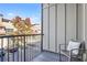 Exterior balcony with comfortable chair and decorative pillow overlooking street and trees at 1199 Huff Nw Rd # 112, Atlanta, GA 30318