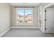 Bright bedroom featuring a large window with neighborhood views and neutral carpet at 1199 Huff Nw Rd # 112, Atlanta, GA 30318
