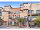 Attractive building featuring brick and stone facade, balconies, and street-side landscaping with trees at 1199 Huff Nw Rd # 112, Atlanta, GA 30318