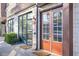 Charming building exterior with stone accents, large windows, and a welcoming orange front door numbered 112 at 1199 Huff Nw Rd # 112, Atlanta, GA 30318