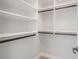 Organized walk-in closet with white shelving and dark rods for ample storage at 1199 Huff Nw Rd # 112, Atlanta, GA 30318