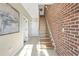 Entry hallway with wooden stairs, brick wall, and tile flooring with natural light at 1199 Huff Nw Rd # 112, Atlanta, GA 30318