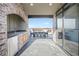 A beautiful outdoor kitchen and patio area features a built-in sink, refrigerator, and a dining table at 1199 Huff Nw Rd # 112, Atlanta, GA 30318