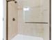 A walk-in shower featuring tile surround, bronze trim and fixtures, and a glass door at 1199 Huff Nw Rd # 112, Atlanta, GA 30318