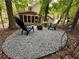 Cozy backyard seating area with chairs and pea gravel, perfect for entertaining at 3962 Fox Glen Dr, Woodstock, GA 30189
