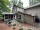 Charming backyard with stone patio, screened-in porch, and a peaceful wooded view at 3962 Fox Glen Dr, Woodstock, GA 30189