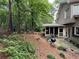 Backyard with a screened porch, patio area, mature trees, and lush landscaping providing a serene outdoor space at 3962 Fox Glen Dr, Woodstock, GA 30189