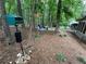 Backyard area featuring bird feeder, mature trees, a seating area, and a view of the home's exterior at 3962 Fox Glen Dr, Woodstock, GA 30189
