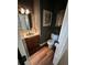 Half bathroom features a wooden vanity, unique sink, modern toilet, and wood flooring at 3962 Fox Glen Dr, Woodstock, GA 30189