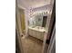 Traditional bathroom featuring a single vanity and a shower with a patterned wallpaper at 3962 Fox Glen Dr, Woodstock, GA 30189