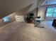 Finished attic featuring lots of space, carpet, a ceiling fan, and a desk at 3962 Fox Glen Dr, Woodstock, GA 30189