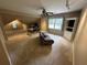 Spacious bonus room featuring a comfortable sofa, built-in shelving, and bright windows at 3962 Fox Glen Dr, Woodstock, GA 30189