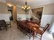 Dining room showcases a large wooden table, chandelier, and access to a stairwell at 3962 Fox Glen Dr, Woodstock, GA 30189