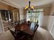 Formal dining room featuring an elegant chandelier, large table, and wainscoting at 3962 Fox Glen Dr, Woodstock, GA 30189