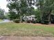 Beautiful two-story home with a well-manicured lawn and landscaping, partially shaded by mature trees at 3962 Fox Glen Dr, Woodstock, GA 30189