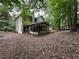 View of home exterior with screened-in porch and wooded backyard at 3962 Fox Glen Dr, Woodstock, GA 30189