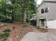 Beautiful home exterior featuring a manicured lawn, mature trees, and attached garage at 3962 Fox Glen Dr, Woodstock, GA 30189
