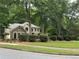 Two-story home exterior featuring a lush, green lawn and professional landscaping at 3962 Fox Glen Dr, Woodstock, GA 30189