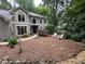 Charming two-story home with landscaped front yard and white outdoor furniture at 3962 Fox Glen Dr, Woodstock, GA 30189