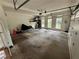 Spacious two-car garage with windows, storage shelves, and overhead lighting at 3962 Fox Glen Dr, Woodstock, GA 30189