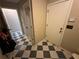 Hallway with checkered flooring, a closet, and a white front door at 3962 Fox Glen Dr, Woodstock, GA 30189