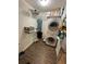 A laundry room with a washer, dryer, storage, and wood-look flooring at 3962 Fox Glen Dr, Woodstock, GA 30189