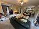 Cozy living room with plush seating, fireplace, and open access to the kitchen area at 3962 Fox Glen Dr, Woodstock, GA 30189