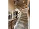 Carpeted staircase with white railings leads to upper level, blending carpet and wood floors at 3962 Fox Glen Dr, Woodstock, GA 30189