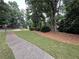 Well-manicured front yard along sidewalk leading to home in a lovely neighborhood with mature trees and landscaping at 3962 Fox Glen Dr, Woodstock, GA 30189