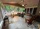 Light-filled sunroom with varied seating and views of the backyard at 3962 Fox Glen Dr, Woodstock, GA 30189