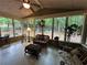 Bright sunroom with comfortable seating and views of the wooded backyard at 3962 Fox Glen Dr, Woodstock, GA 30189