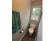 Powder room with a toilet, wood-look flooring, and window at 3962 Fox Glen Dr, Woodstock, GA 30189