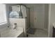 Bright bathroom featuring marble tile, glass shower, and white trim at 495 Sterling Creek Way, Loganville, GA 30052