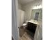 Bathroom features a shower with a curtain, vanity with storage, and modern fixtures at 495 Sterling Creek Way, Loganville, GA 30052