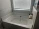Bathroom with tile, bright lighting, and a white bathtub at 495 Sterling Creek Way, Loganville, GA 30052