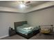 Bedroom with a ceiling fan, carpeted floors, and a gray color scheme at 495 Sterling Creek Way, Loganville, GA 30052