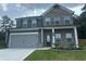 Beautiful two-story home with brick and gray accents, a two-car garage, and an inviting front yard at 495 Sterling Creek Way, Loganville, GA 30052