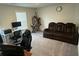Large living room with computer setup, sofa, and a big window, perfect for relaxing or working at 495 Sterling Creek Way, Loganville, GA 30052