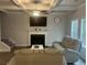 Cozy living room with a fireplace, coffered ceilings, a ceiling fan, and comfortable seating at 495 Sterling Creek Way, Loganville, GA 30052