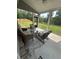 Screened patio with stylish outdoor furniture, ceiling fan, and backyard view at 495 Sterling Creek Way, Loganville, GA 30052