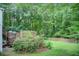 Lush backyard featuring a multi-level deck, mature trees, and a well-manicured lawn at 652 Trailwood Sw Ln, Marietta, GA 30064