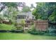 Spacious backyard with a multi-tiered deck featuring a grill and a charming wooden pergola at 652 Trailwood Sw Ln, Marietta, GA 30064