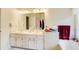 Bright bathroom with white cabinets, double sinks, and tile floors at 652 Trailwood Sw Ln, Marietta, GA 30064