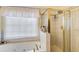 Bright bathroom with a shower and bathtub enclosed with gold trim at 652 Trailwood Sw Ln, Marietta, GA 30064