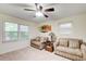 Bedroom features 2 windows for natural light, light beige carpet, and soft, neutral furnishings at 652 Trailwood Sw Ln, Marietta, GA 30064